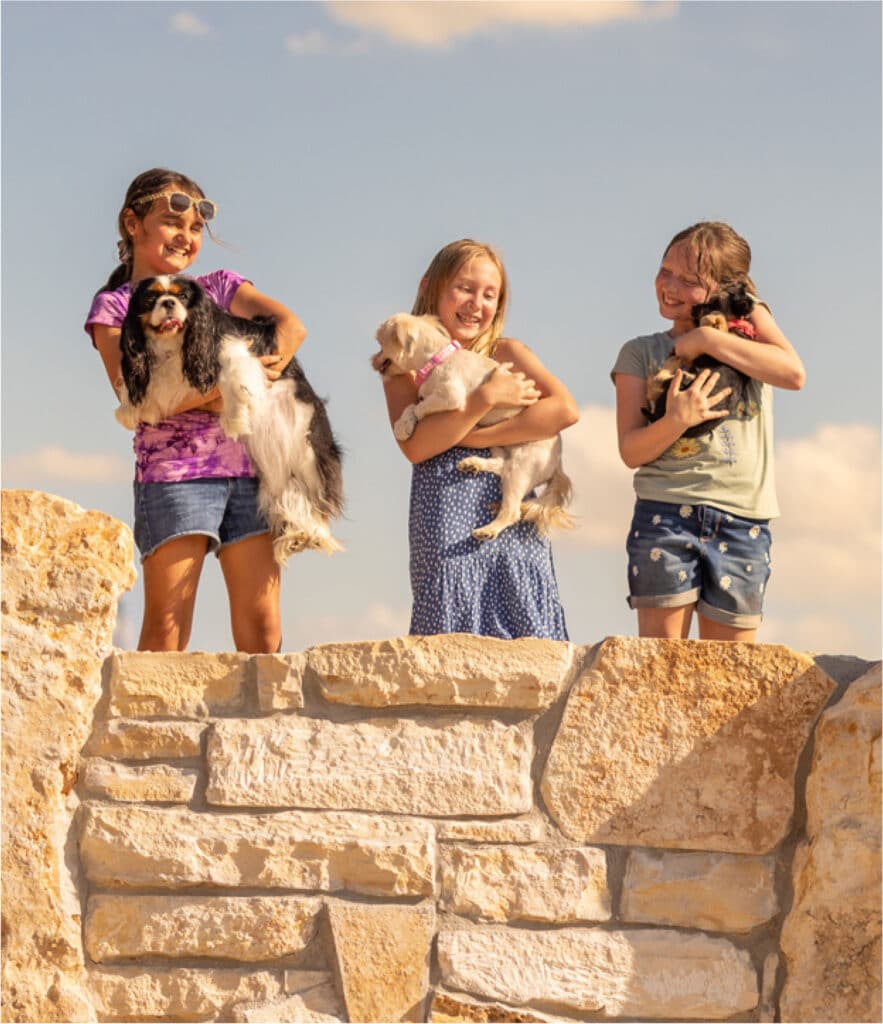 kids holding their dogs